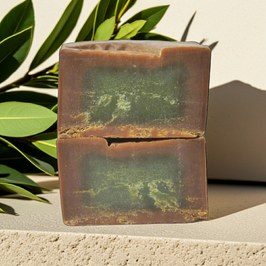 Original Aleppo Laurel Soap by Fansa 40% — two tan bars stacked on a light textured surface, with green leaves