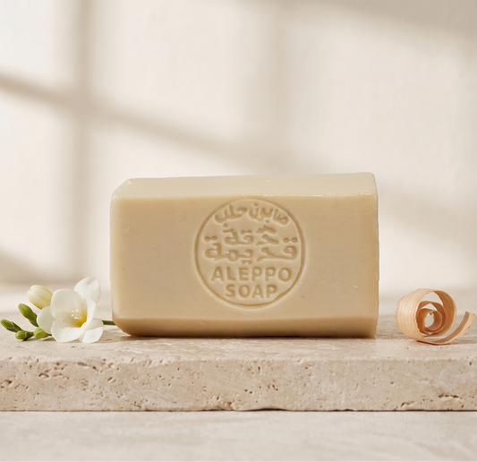 Musk of Purity Aleppo Soap by Dakka Kadima — ivory stamped soap bar with white flowers and curled wood