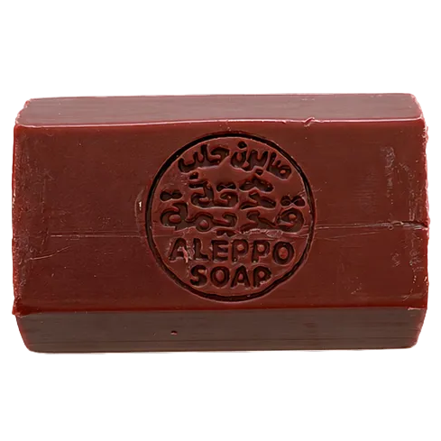 Close-up of Aleppo soap showing engraved Arabic seal, natural handmade olive oil soap with artisanal texture