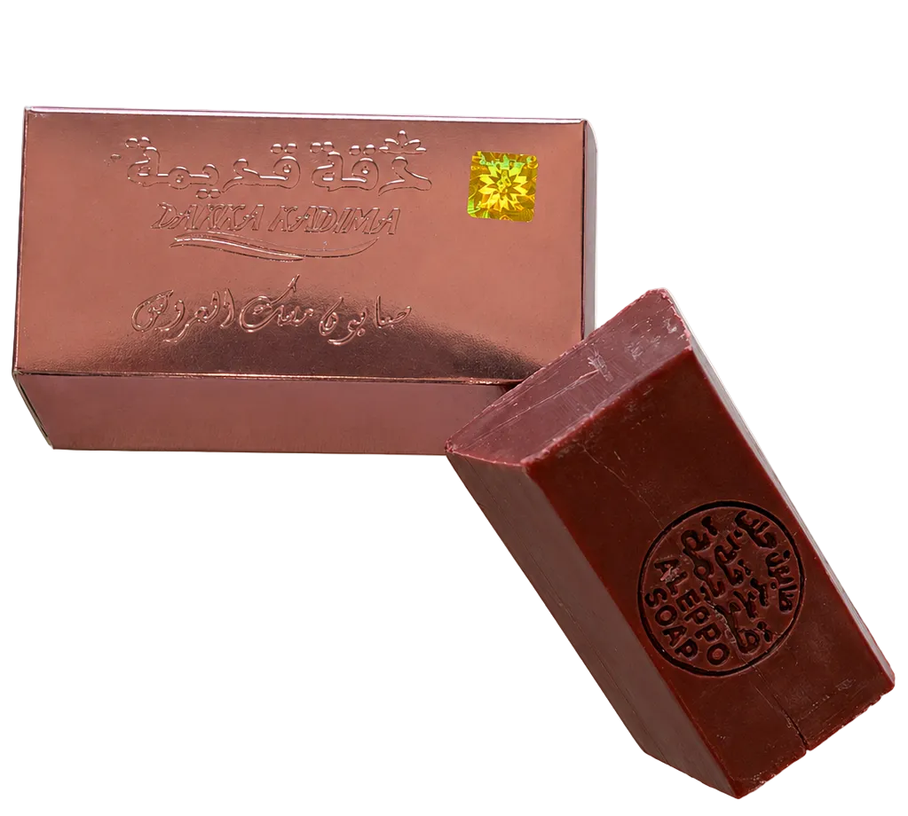 Aleppo soap bar beside premium packaging, traditional Syrian olive and laurel oil soap with handcrafted quality