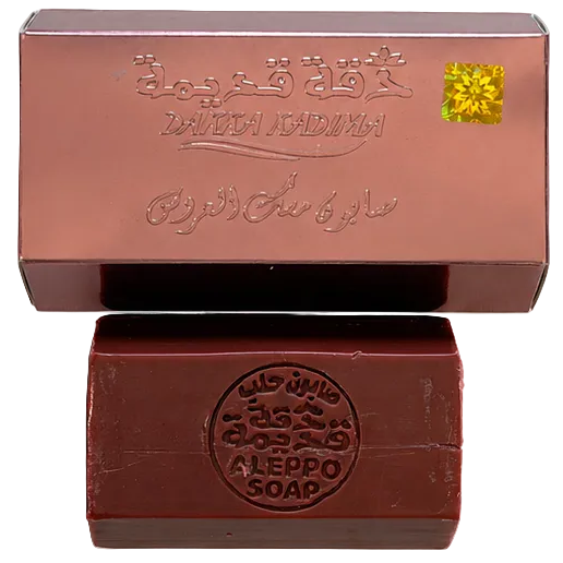 Aleppo soap bar beside premium packaging, traditional Syrian olive and laurel oil soap with handcrafted quality