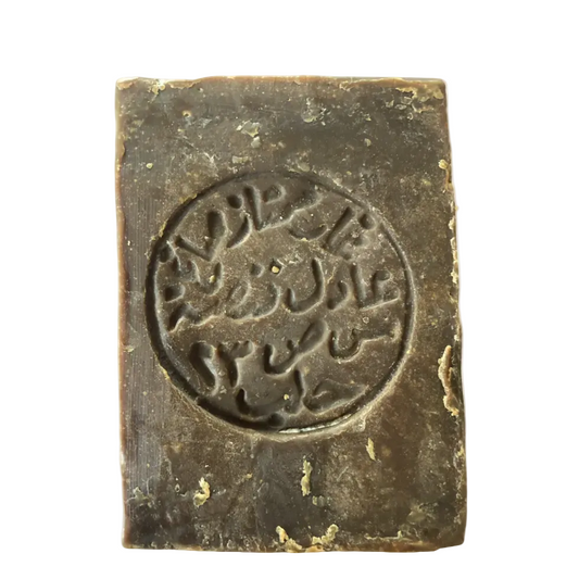 Traditional Aleppo Laurel Soap by Fansa 12% front view with Arabic stamp on green laurel soap bar | صابون غار حلبي من فنصة 12% منظر أمامي مع ختم عربي على لوح صابون الغار الأخضر